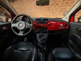 a red car with black leather seats and a steering wheel