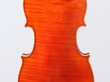 an orange violin with a wooden back and bow on a white background