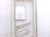 a white box containing a charger and a cable