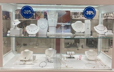 a glass display case with a lot of jewelry in it