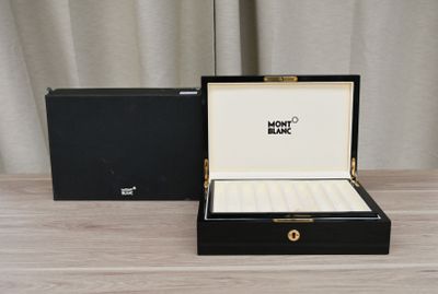 a black box with a watch inside of it on a table
