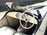 a white and black car with a steering wheel and dashboard