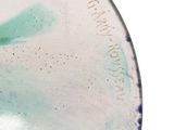 a close up of a plate with a flower design on it