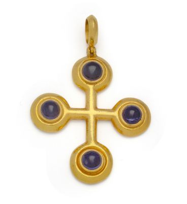 une image représentant une croix en or ornée de pierres bleues sur fond blanc