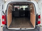 the back of a white van with its doors open in a parking lot