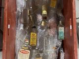 many bottles of alcohol in a red box on a table
