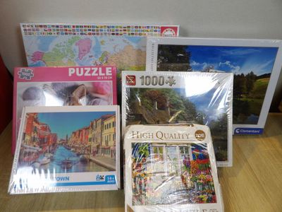 many puzzles on the table with pictures on them