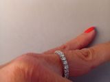 a woman ' s hand with a diamond ring on it