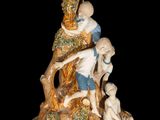 a figurine of a boy and a boy climbing a tree