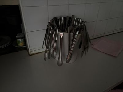 de nombreuses cuillères dans un porte-cuillères en argent posé sur un comptoir
