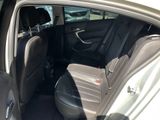the back seats of a car with the door open in a parking lot