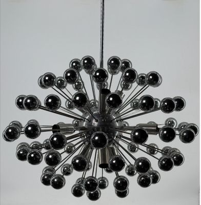 a black and white photo of a chandelier with chrome balls