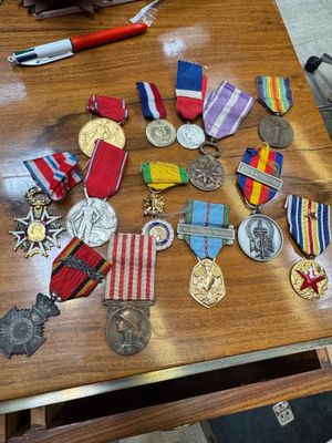 a wooden table with a lot of medals on it
