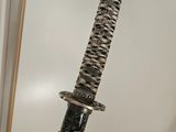 a sword that is sitting on top of a table