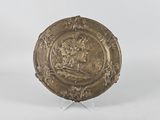 a gold plate with an image of a woman on it