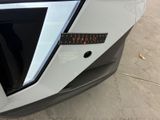 a close up of the front of a car with a sticker on it