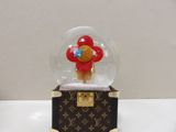 a snow globe with a teddy bear inside of it