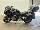 a black motorcycle parked inside of a garage