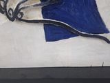 a painting of a blue and white flag on display