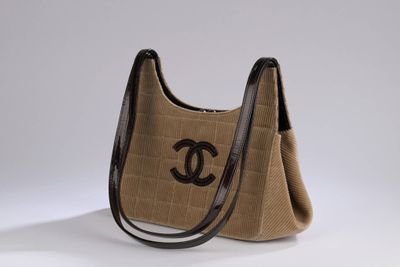 a brown and black handbag with a black logo on it