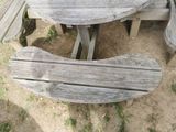 a wooden table and two benches on the ground
