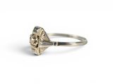 a close up of a silver ring with a flower on it
