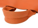 an orange purse with a strap hanging from it ' s side