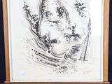 drawing of a man ' s face on an easel in front of a blue background