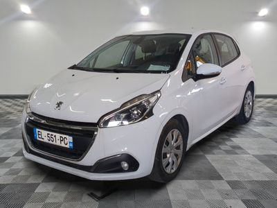 the small white car is parked in a large room