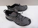 pair of men ' s hiking shoes on a white surface