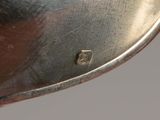 a close up view of a silver plate with a number 5 on it