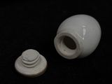a small white vase with a lid and a smaller white one