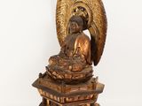 an image of a statue of a buddha sitting on a pedestal