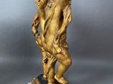 pair of antique bronze figurines of a man and a woman on a pedestal