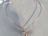 silver plated necklace with a pearl bead hanging from it ' s end