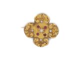 a close up of a gold and diamond cross pendant on a white background