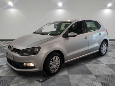 the silver volkswagen polo is parked on a checkered tile floor