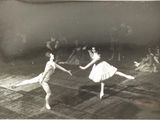 two young girls that are performing in a dance class