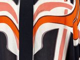 an orange and black shirt with a white and black design