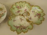two plates with flowers on them on a table