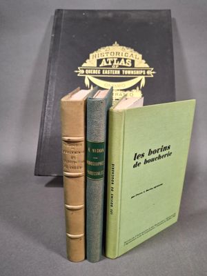 deux livres posés l'un sur l'autre devant une bibliothèque