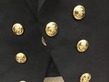 a close up of a black jacket with gold buttons on it