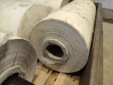 two rolls of paper sitting on top of a pallet