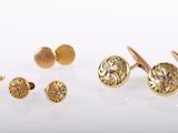 three pairs of gold cufflinks and a pair of gold cufflinks