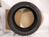 a close up of a tire sitting on top of a cardboard box