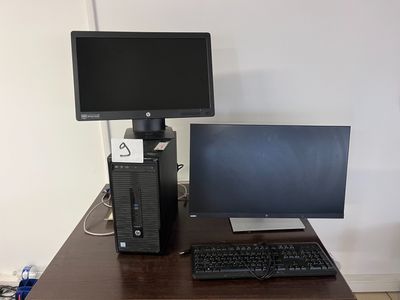 a desktop computer sitting on a desk next to a monitor and keyboard
