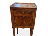 a small wooden table with a drawer on it