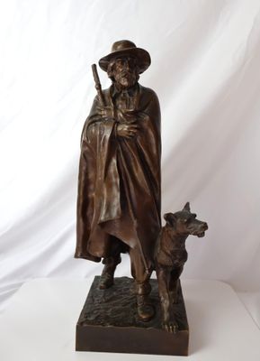 statue en bronze représentant un homme avec un chien, sur fond blanc