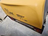a close up of a yellow boat on the ground