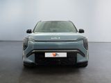 the front end of a blue electric vehicle in a white room